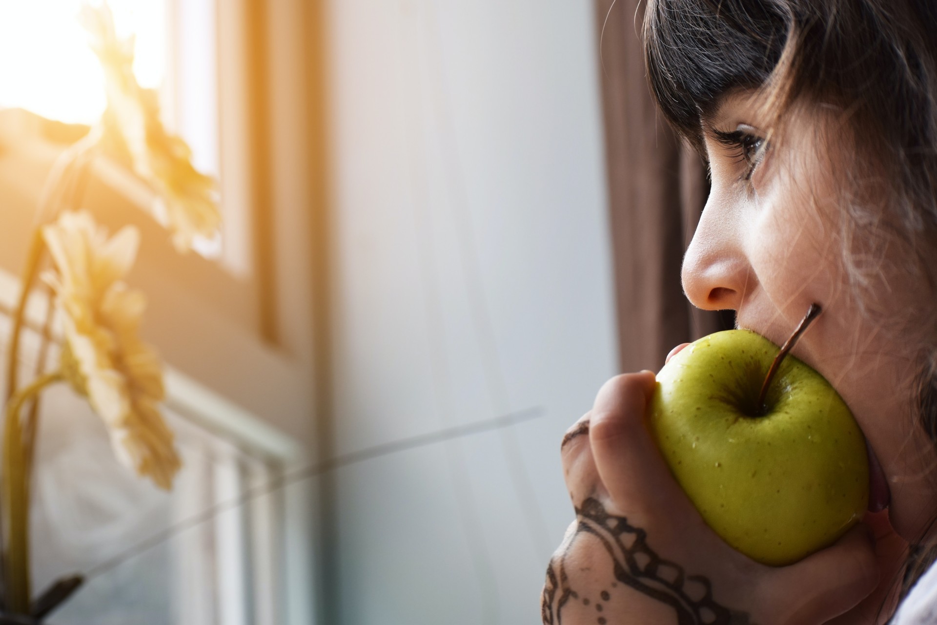 Biting into a green apple