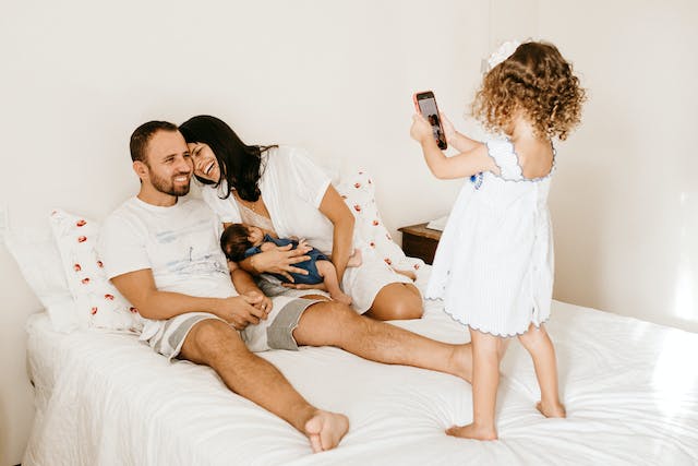 Woman breastfeeding in bed with her family