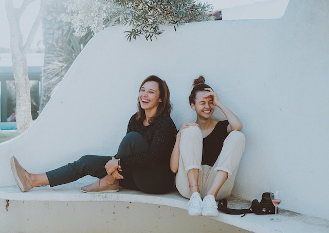 two girls laughing outside