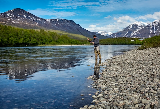 middle-age man fishing on a lake