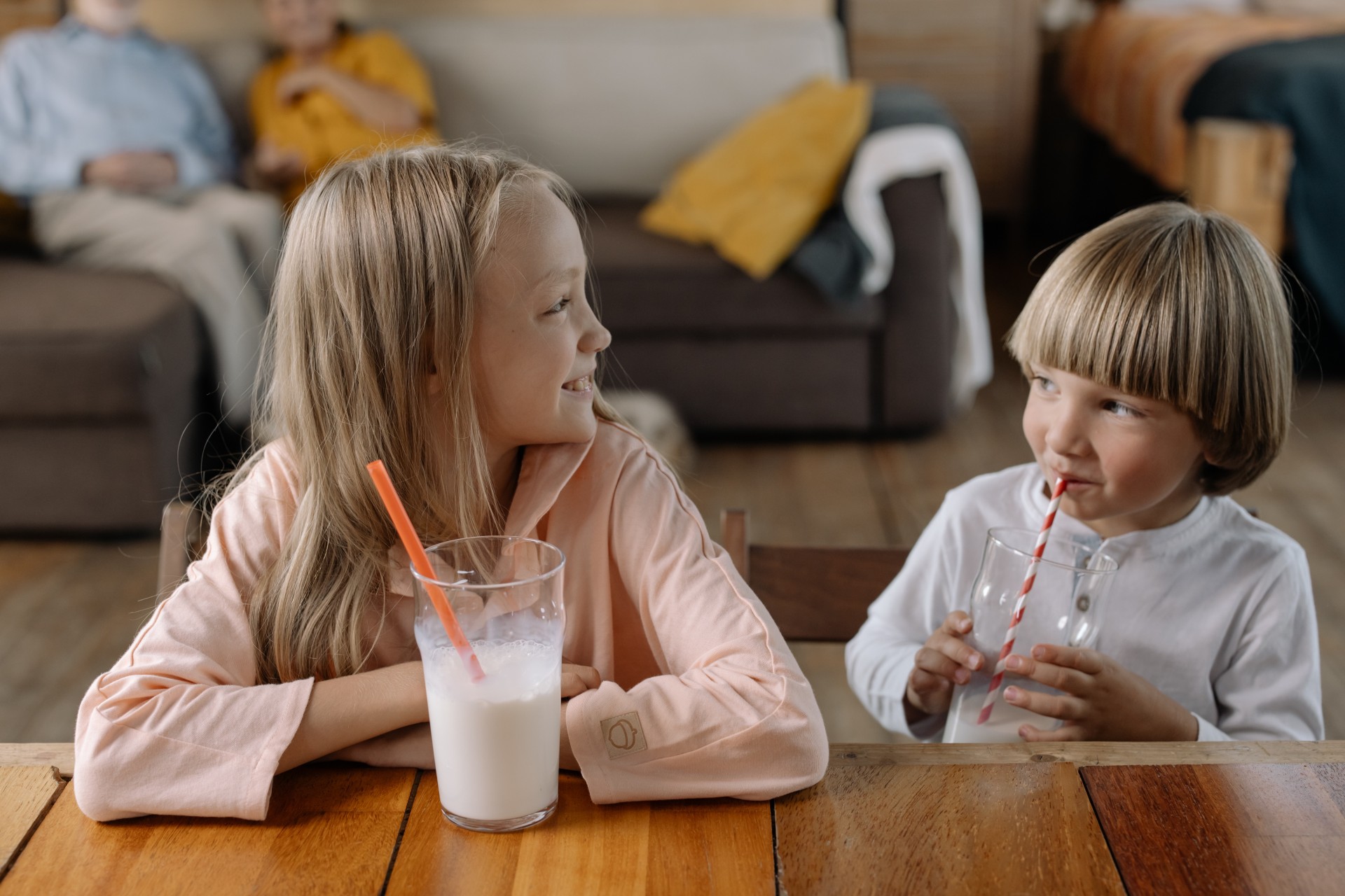 Two kids drinking milk