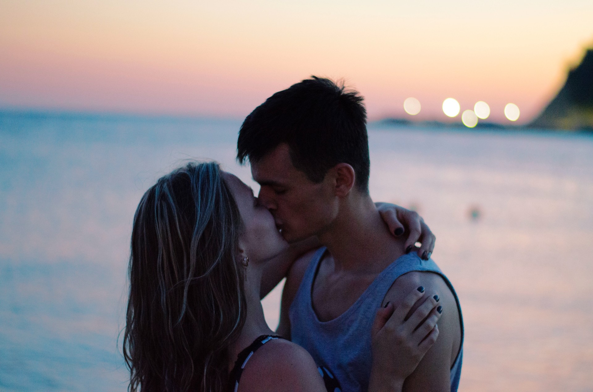 Man and woman kissing on the shore