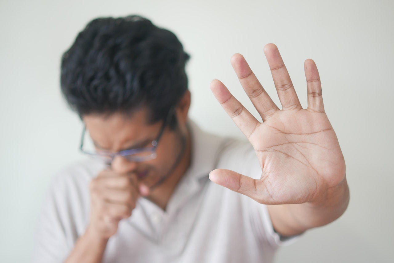 A man coughing