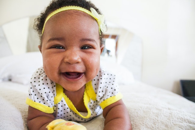 A smiling baby laying down