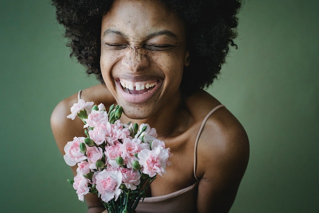 Smiling, happy woman holding flowers