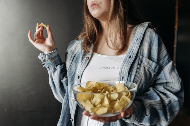 woman eating potato chips
