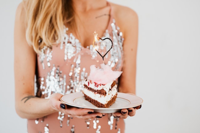 Woman holding a slice of cake