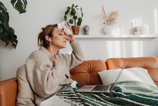 woman sitting on the couch sweating