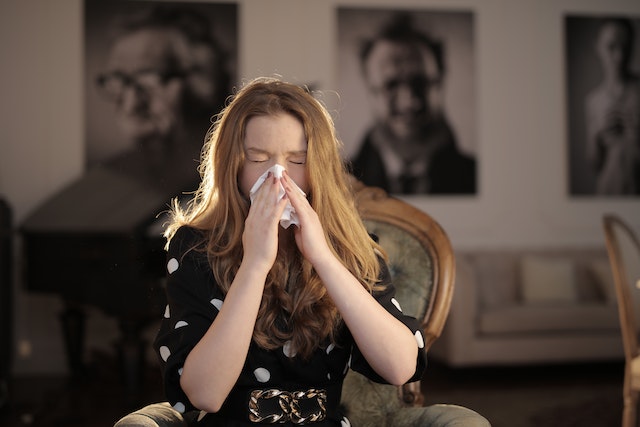 Woman wiping her nose with a tissue